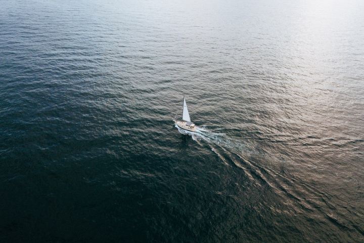 White boat sailing in the middle of the ocean