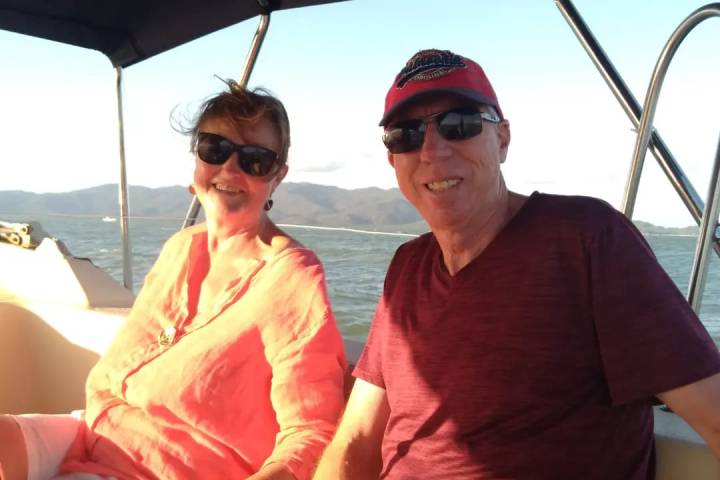 a man and a woman sitting on a boat