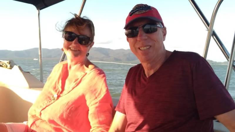 a man and a woman sitting on a boat