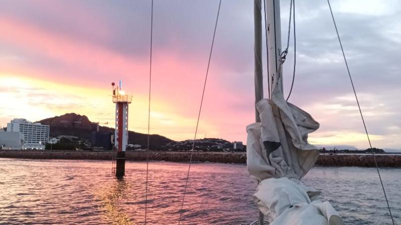 a person sitting in a boat on a body of water