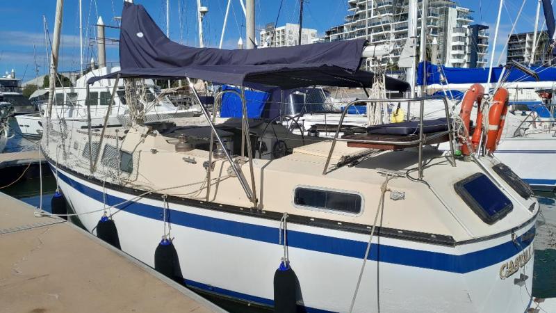 a boat is docked next to a body of water