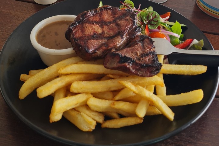 a plate of food is sitting on the side of fries