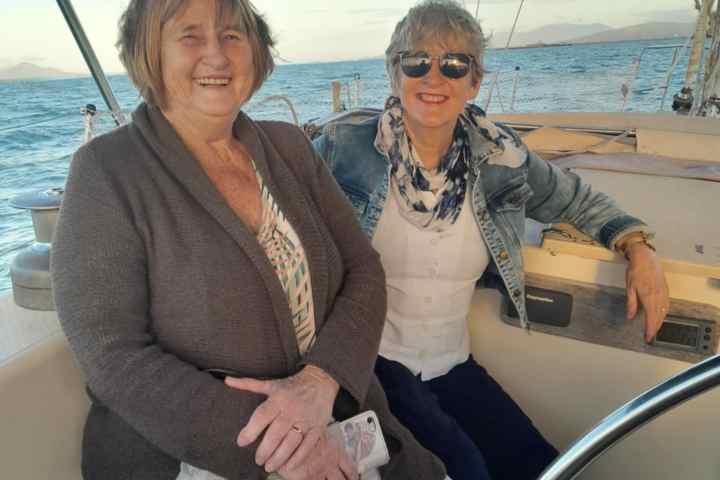 a couple of people that are sitting on a boat posing for the camera