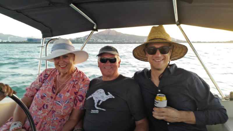 a group of people sitting in a boat on a body of water